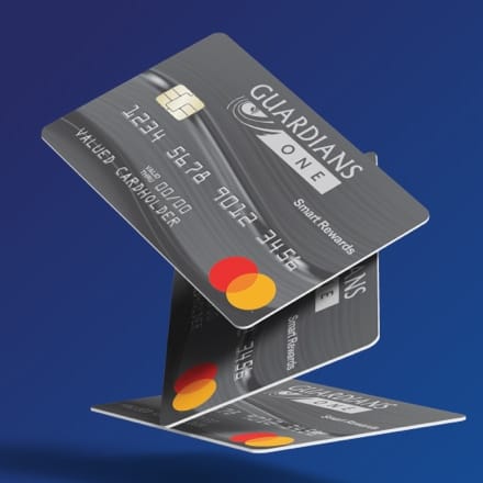 Three Guardians One Mastercard credit cards oriented to give the illussion that they are in motion falling down.