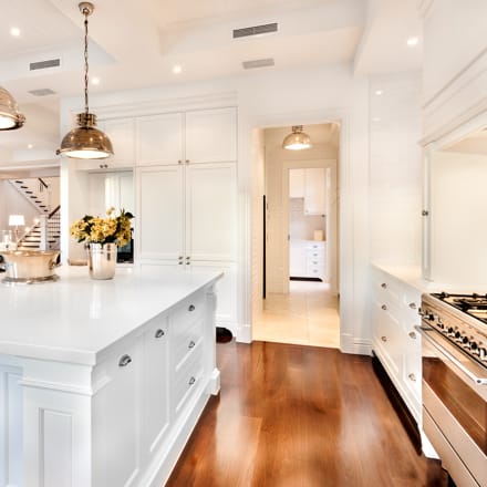 A beautiful, white, modern kitchen.