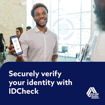 A young man presenting an IDCheck to a teller.
