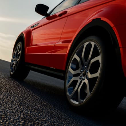 A side-panel view of a red car.