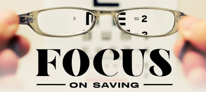 An eyeglass looking at a snellen chart. At the bottom, the words: focus on saving.