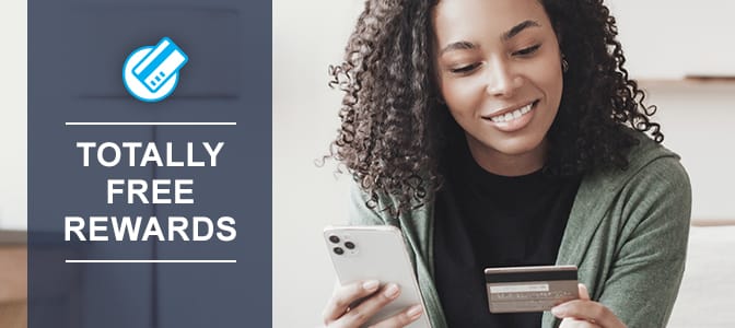 A young woman holding a debit card and a smart phone. At the left, the words: totally free rewards.