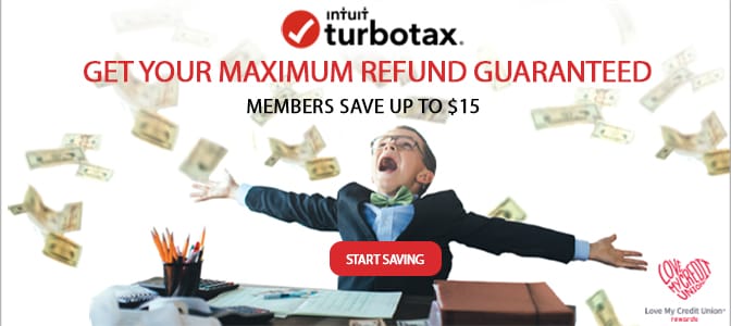 A young boy dressed as an accountant sitting at a desk with outstretched arms and dollar bills in the air.