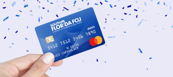 The SFFCU, A Division of Guardians CU Mastercard Debit Card surrounded by confetti.