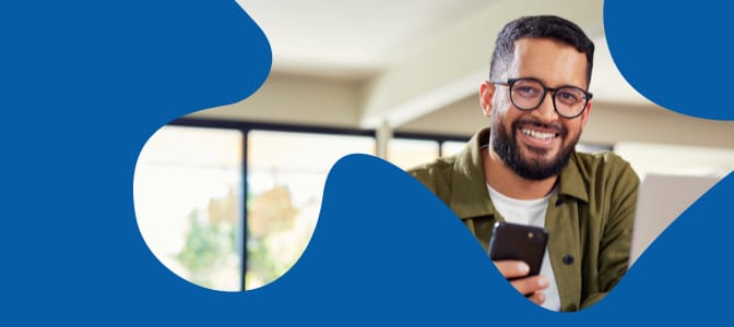 The face of a similing man in a clip mask of a puzzle piece against a blue background.