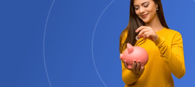 A teenager depositing a coin into a piggy bank.