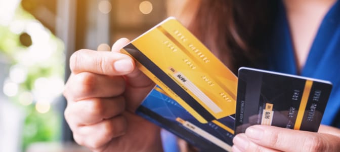 Female hands holding three credit cards.