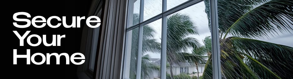 A view looking out the window onto a storm with rain and swaying palm trees. At the left, the words: secure your home.