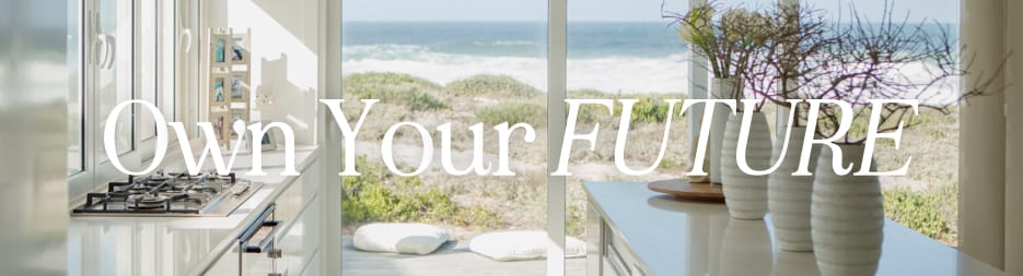 A view through a modern, white kitech into the ocean front backyard. At the center, the words: own your future.