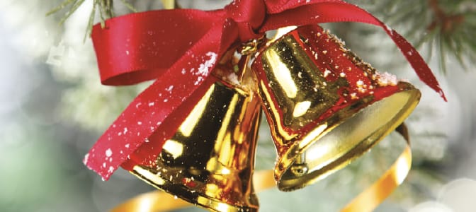 Two gold bells tied with a red bow