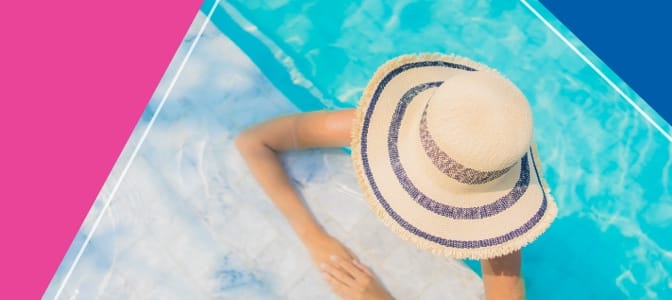 A woman with a sun hat in a pool.