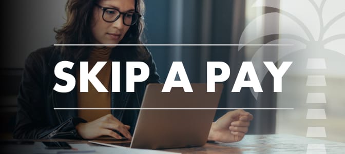 A woman using a laptop. Across the middle, the words: skip a pay.