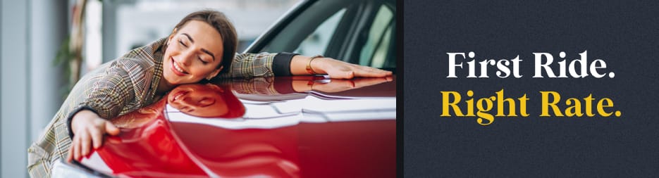 Woman smiling and embracing a new red car at a dealership. At the right, the words: first ride. right rate.