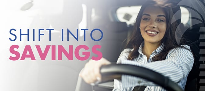 A young woman smiling while driving a car. To the left, the words: Shift into savings.