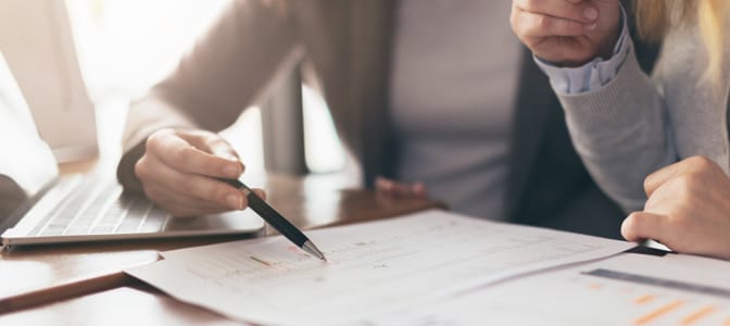 Top-view of a professional looking at tax papers.