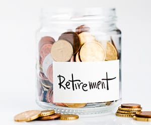 A jar of coins with a label containg the word retirement
